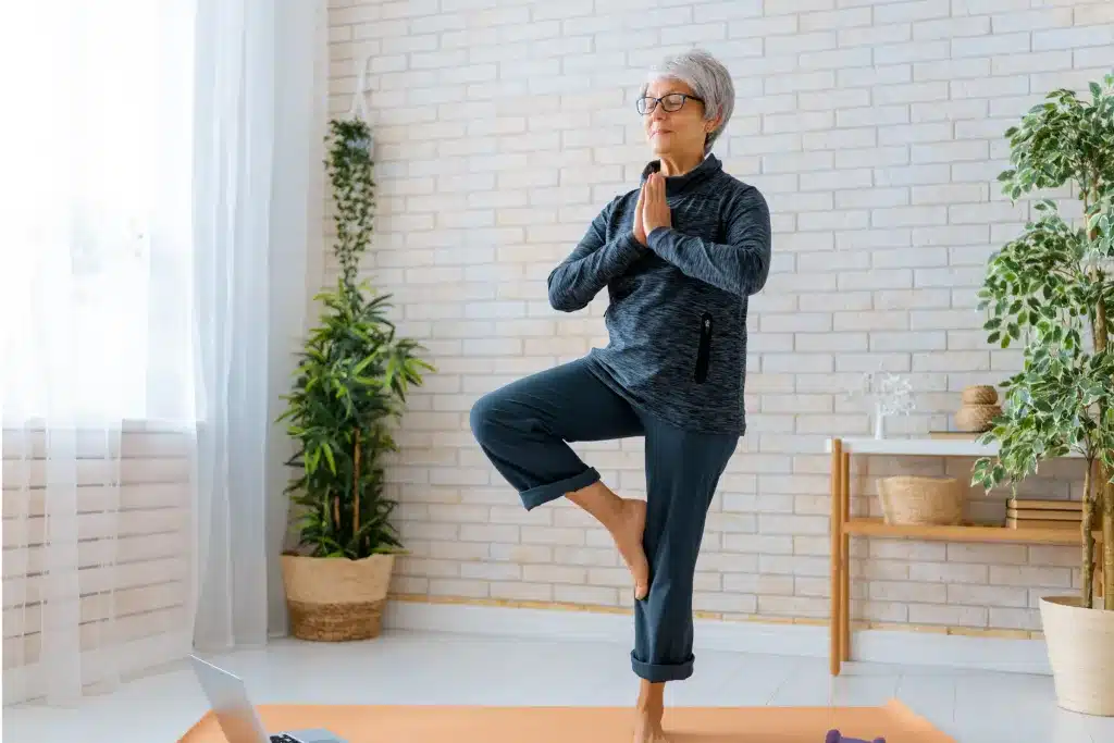 Frau in den besten Jahren Frau in den besten Jahren praktiziert Yoga.